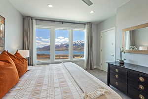 Bedroom with baseboards, recessed lighting, a water view, and light colored carpet
