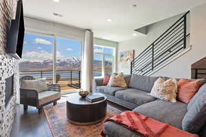 Living room with a mountain view, visible vents, recessed lighting, a large fireplace, and wood-type flooring