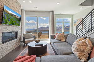 Living area featuring recessed lighting, wood finished floors, visible vents, a mountain view, and a fireplace