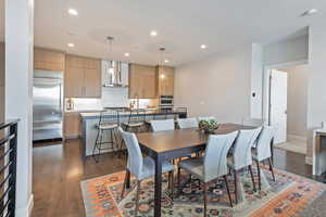 Dining room featuring recessed lighting, dark wood finished floors, and baseboards