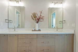 Bathroom featuring a sink and double vanity