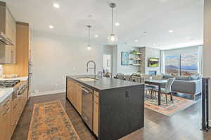 Kitchen featuring a sink, a center island with sink, recessed lighting, modern cabinets, and appliances with stainless steel finishes