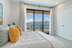 Bedroom featuring recessed lighting, access to exterior, a water and mountain view, a closet, and carpet flooring