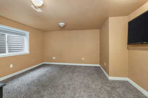 Unfurnished room with carpet floors, visible vents, and baseboards