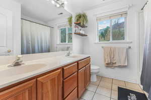 Full bathroom with tile patterned floors, a sink, visible vents, and double vanity