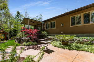 Back of property featuring a ceiling fan and a patio