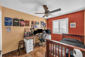 Bedroom with a desk and a ceiling fan