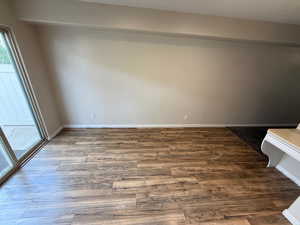 Unfurnished room with baseboards and wood finished floors
