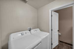 Laundry room with washing machine and clothes dryer and a textured ceiling