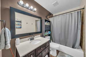 Bathroom with vanity and shower / bathtub combination with curtain