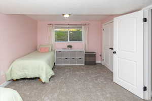 Carpeted bedroom featuring baseboards