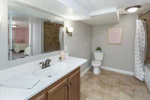 Bathroom with toilet, baseboards, visible vents, vanity, and connected bathroom