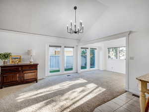 Formal dining area with large windows.