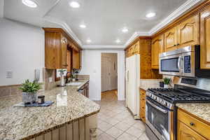 Kitchen with a stainless appliances and granite countertops.