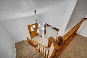 Staircase with lofted ceiling.
