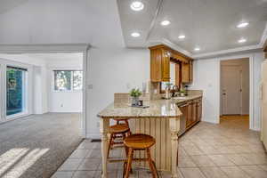 Kitchen featuring a kitchen breakfast bar, and view of formal dining area.