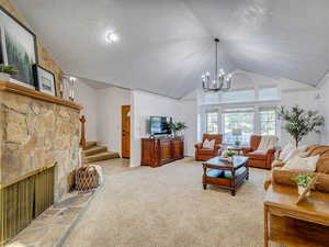 Front living room with lofted ceiling, and a fireplace