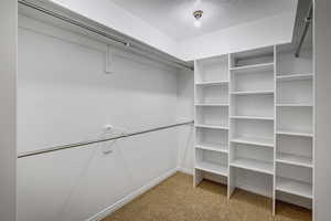 Primary bedroom walk in closet.