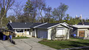 Single story home, fence, a front lawn, an attached garage, and driveway