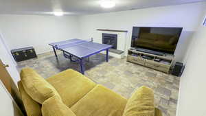 Playroom with a brick fireplace.