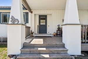 Doorway to property with covered porch