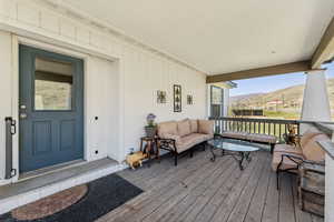 Deck with outdoor lounge area and a mountain view