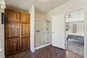 Bathroom featuring ensuite bathroom, a shower stall, and ceiling fan