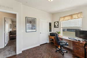 Office area with baseboards and visible vents