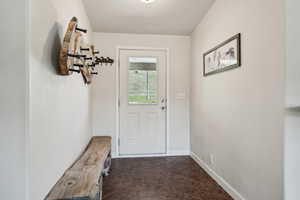 Doorway to outside with baseboards