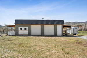 Detached garage with fence and a mountain view