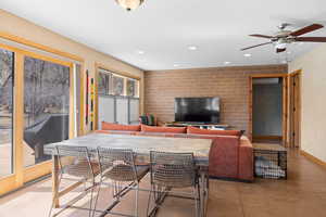 Dining space with aspen baseboards, concrete flooring, recessed lighting, and ceiling fan