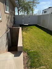 View of yard featuring a gate and fence