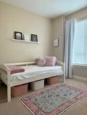 Bedroom with carpet flooring and baseboards