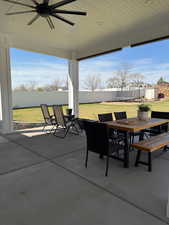 View of patio featuring a fenced backyard, outdoor dining space, and a ceiling fan