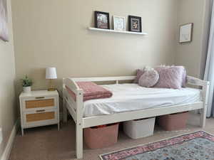 Carpeted bedroom featuring baseboards