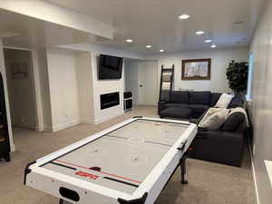 Game room featuring recessed lighting, a fireplace, carpet flooring, and baseboards