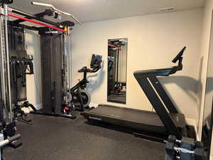 Exercise room featuring a textured ceiling and visible vents