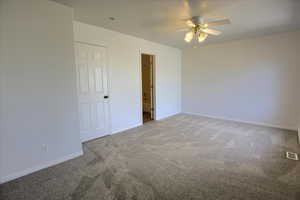 Unfurnished bedroom with ceiling fan, baseboards, carpet flooring, and visible vents