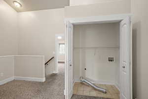 Washroom featuring hookup for an electric dryer, baseboards, carpet flooring, laundry area, and washer hookup