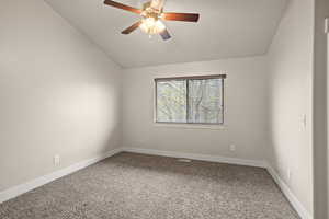 Unfurnished room with ceiling fan, lofted ceiling, baseboards, and carpet