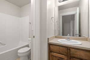 Full bath featuring shower / bathtub combination, toilet, and vanity
