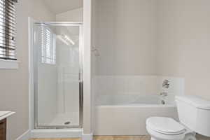 Full bathroom with a shower stall, a garden tub, toilet, and vanity