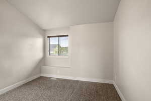 Carpeted empty room with baseboards and visible vents