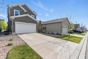 View of front facade with stucco siding and concrete driveway