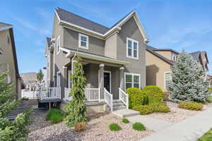 Traditional-style home featuring stucco siding and a porch