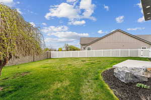 View of yard featuring a fenced backyard and a patio