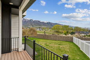Exterior space featuring a yard, a fenced backyard, and a mountain view
