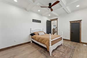 Bedroom featuring recessed lighting, baseboards, beam ceiling, and light wood-style floors