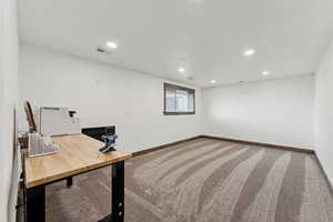 Unfurnished office with visible vents, baseboards, carpet flooring, and recessed lighting
