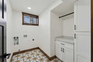 Clothes washing area with washer hookup, electric dryer hookup, cabinet space, baseboards, and recessed lighting